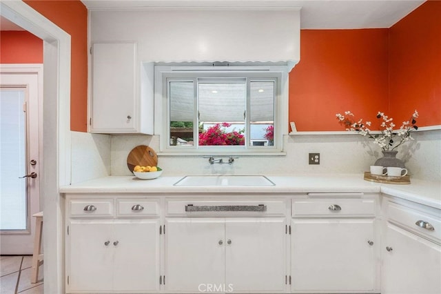 5855 Lemon Ave, Long Beach, CA 90805 - kitchen featuring white cabinetry, light countertops, and tasteful backsplash