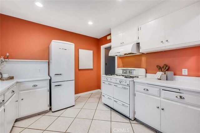 5855 Lemon Ave, Long Beach, CA 90805 - kitchen featuring range with two ovens, fridge, under cabinet range hood, white cabinets, and light countertops