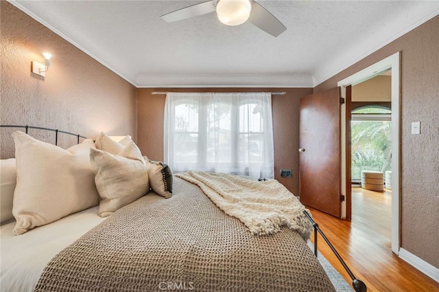 5855 Lemon Ave, Long Beach, CA 90805 - bedroom with a textured wall, light wood-type flooring, crown molding, a ceiling fan, and a textured ceiling