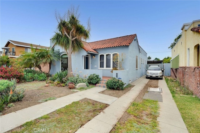 5855 Lemon Ave, Long Beach, CA 90805 - mediterranean / spanish house with a tiled roof, driveway, and stucco siding