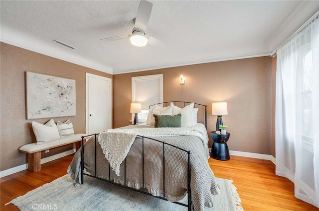 5855 Lemon Ave, Long Beach, CA 90805 - bedroom with wood finished floors, ceiling fan, crown molding, and a textured ceiling