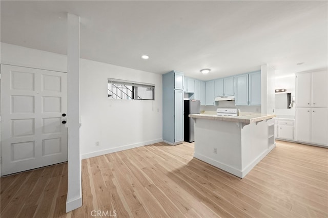 4647 Pico St Unit 101, San Diego, CA 92109 - kitchen featuring stove, freestanding refrigerator, light countertops, light wood finished floors, and under cabinet range hood