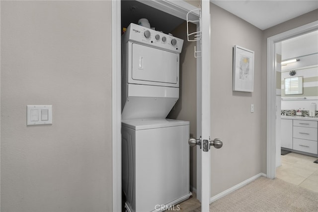 10554 Cannon Dr, Rancho Cucamonga, CA 91730 - laundry room featuring stacked washer / drying machine and light carpet