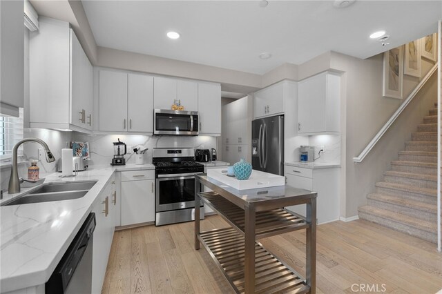 10554 Cannon Dr, Rancho Cucamonga, CA 91730 - kitchen featuring stainless steel appliances, light wood-type flooring, backsplash, light stone countertops, and recessed lighting