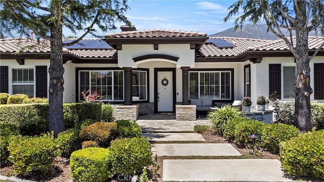 949 Moody Pl, Claremont, CA 91711 - mediterranean / spanish-style home with solar panels, a tile roof, a chimney, and stucco siding
