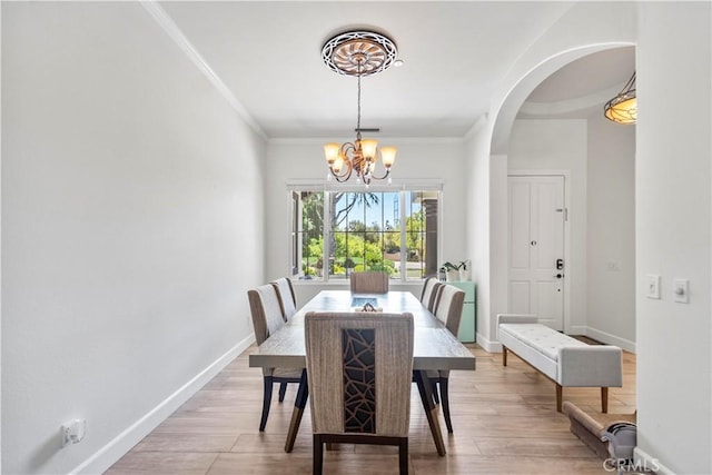 949 Moody Pl, Claremont, CA 91711 - dining area with a chandelier, light wood finished floors, arched walkways, and ornamental molding