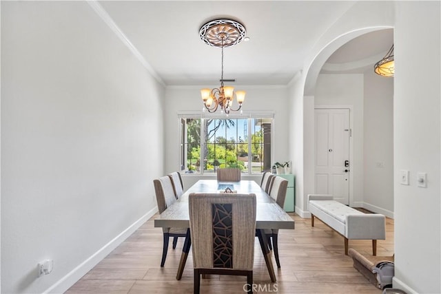 949 Moody Pl, Claremont, CA 91711 - dining area featuring a chandelier, arched walkways, ornamental molding, and light wood-style flooring