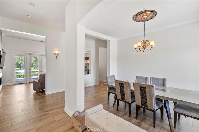 949 Moody Pl, Claremont, CA 91711 - dining space with a chandelier, light wood-style flooring, and crown molding