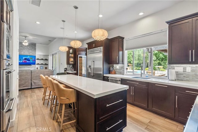 949 Moody Pl, Claremont, CA 91711 - kitchen featuring stainless steel appliances, open floor plan, backsplash, a kitchen island, and recessed lighting