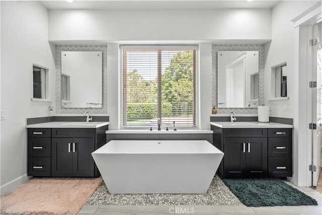 949 Moody Pl, Claremont, CA 91711 - full bathroom with a freestanding bath, two vanities, and tile patterned flooring