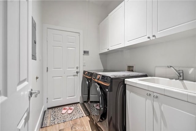 949 Moody Pl, Claremont, CA 91711 - laundry area with cabinet space, independent washer and dryer, wood finished floors, and electric panel