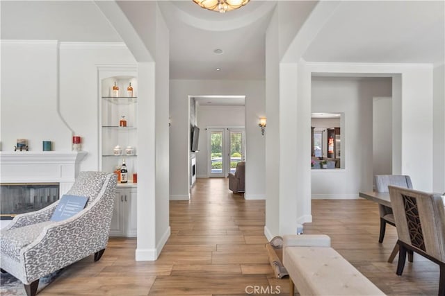 949 Moody Pl, Claremont, CA 91711 - foyer entrance with light wood-style flooring, a glass covered fireplace, and ornamental molding