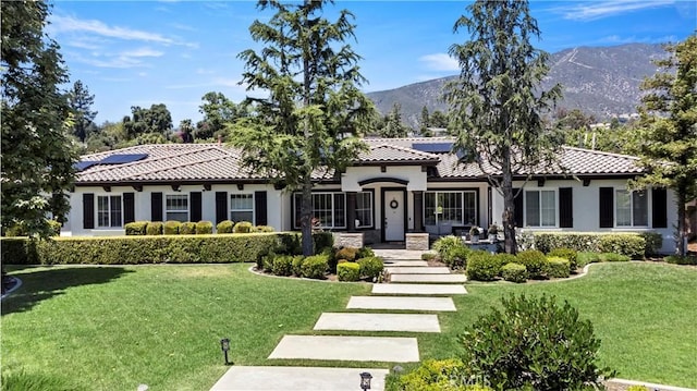 949 Moody Pl, Claremont, CA 91711 - view of front of home featuring a front yard, solar panels, stucco siding, a mountain view, and a tile roof