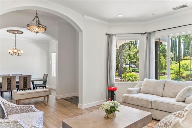 949 Moody Pl, Claremont, CA 91711 - living room featuring arched walkways, a chandelier, light wood-style flooring, ornamental molding, and recessed lighting