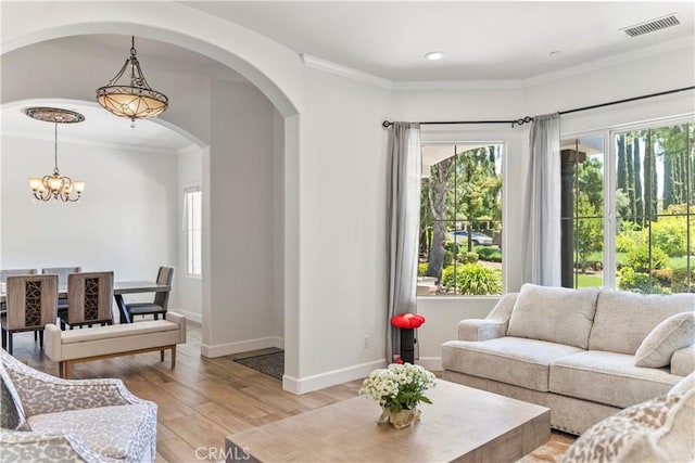 949 Moody Pl, Claremont, CA 91711 - living room with arched walkways, a chandelier, light wood-type flooring, ornamental molding, and recessed lighting