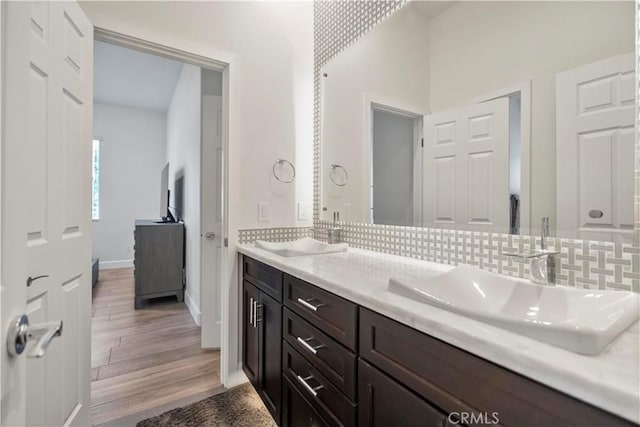 949 Moody Pl, Claremont, CA 91711 - bathroom with tasteful backsplash, double vanity, and wood finished floors
