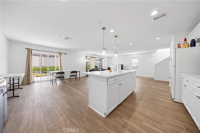 20225 Breeze Blooms Dr, Riverside, CA 92507 - kitchen featuring freestanding refrigerator, white cabinets, recessed lighting, light wood finished floors, and light countertops