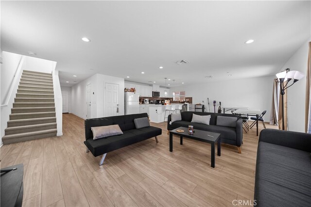 20225 Breeze Blooms Dr, Riverside, CA 92507 - living room featuring stairs, light wood-style flooring, and recessed lighting