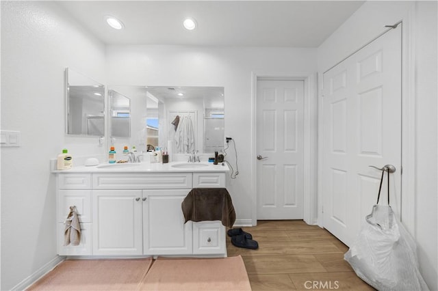 20225 Breeze Blooms Dr, Riverside, CA 92507 - bathroom featuring double vanity, wood finished floors, and recessed lighting