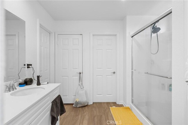 20225 Breeze Blooms Dr, Riverside, CA 92507 - full bathroom with a stall shower, wood finished floors, and vanity