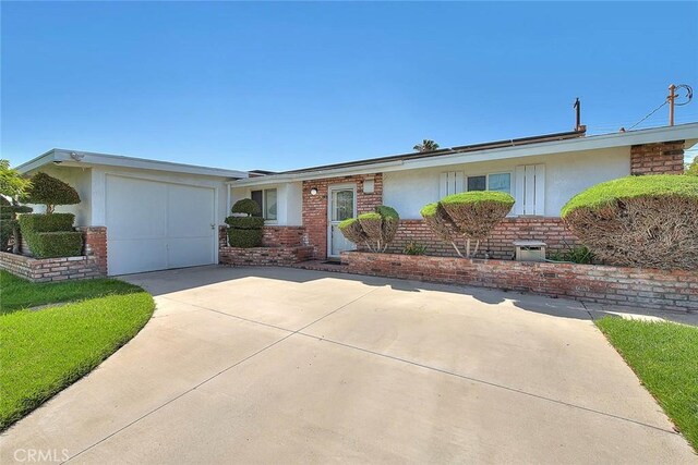 17109 E Orkney St, Azusa, CA 91702 - ranch-style home with stucco siding, concrete driveway, brick siding, and a garage