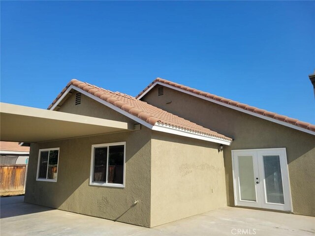 955 Mill Iron Way, San Jacinto, CA 92583 - back of house with french doors, stucco siding, and a patio area