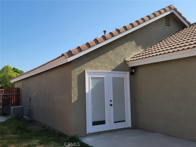 955 Mill Iron Way, San Jacinto, CA 92583 - doorway to property featuring a tiled roof, stucco siding, french doors, and a patio