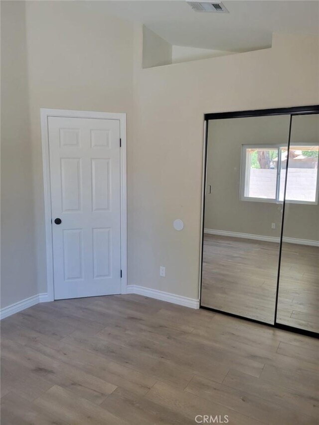955 Mill Iron Way, San Jacinto, CA 92583 - unfurnished bedroom featuring wood finished floors and a closet
