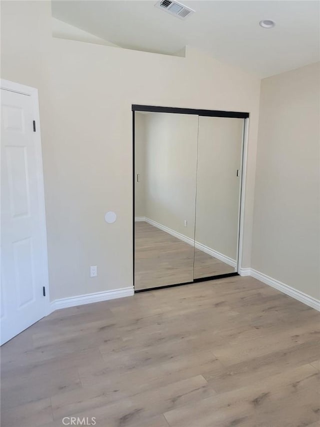 955 Mill Iron Way, San Jacinto, CA 92583 - unfurnished bedroom with wood finished floors and a closet