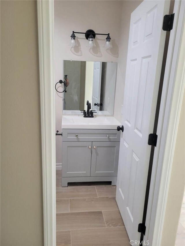 955 Mill Iron Way, San Jacinto, CA 92583 - bathroom featuring vanity and wood finish floors