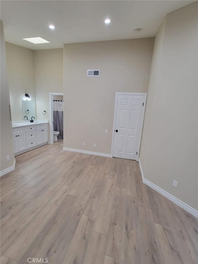 955 Mill Iron Way, San Jacinto, CA 92583 - unfurnished living room featuring light wood-type flooring and recessed lighting