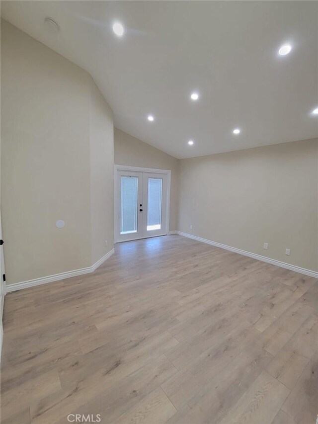 955 Mill Iron Way, San Jacinto, CA 92583 - spare room featuring french doors, lofted ceiling, light wood-style flooring, and recessed lighting