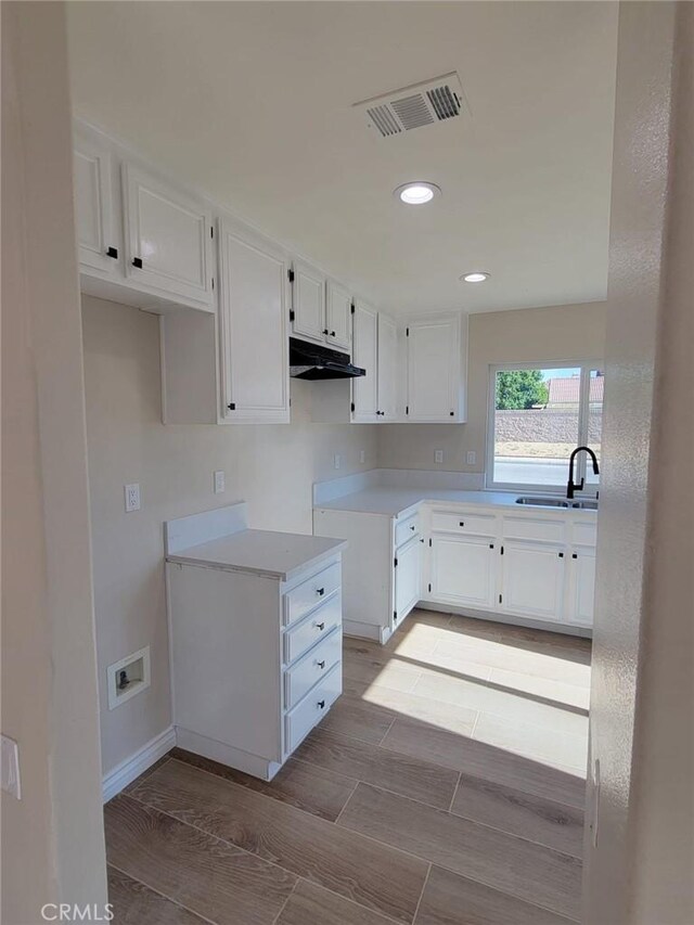 955 Mill Iron Way, San Jacinto, CA 92583 - kitchen featuring white cabinetry, under cabinet range hood, recessed lighting, and light countertops