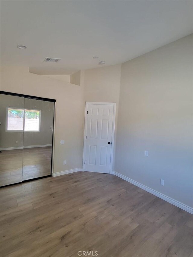 955 Mill Iron Way, San Jacinto, CA 92583 - unfurnished bedroom with wood finished floors and a closet
