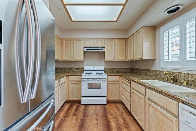 2547 Orange Ave Unit D, Costa Mesa, CA 92627 - kitchen with white appliances, light brown cabinets, under cabinet range hood, wood finished floors, and stone countertops