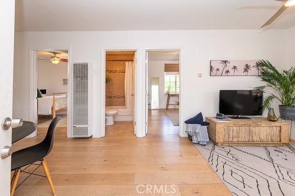 1186 Buelah Ave, City Terrace, CA 90063 - living room featuring a heating unit, a ceiling fan, and light wood-style flooring