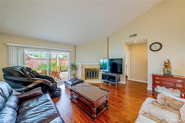 25312 Cassandra Ct, Mission Viejo, CA 92691 - living room with wood finished floors, a tiled fireplace, and high vaulted ceiling