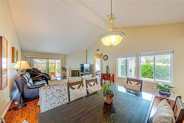 25312 Cassandra Ct, Mission Viejo, CA 92691 - dining space with wood finished floors, beamed ceiling, high vaulted ceiling, and a glass covered fireplace