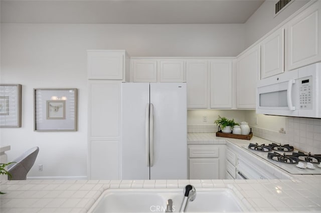 1501 Reggio Aisle, Irvine, CA 92606 - kitchen with white appliances, tile countertops, and white cabinetry