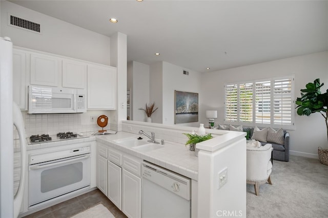 1501 Reggio Aisle, Irvine, CA 92606 - kitchen featuring white appliances, a peninsula, white cabinets, open floor plan, and recessed lighting