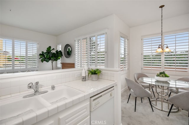 1501 Reggio Aisle, Irvine, CA 92606 - kitchen with dishwasher, plenty of natural light, light carpet, and a chandelier