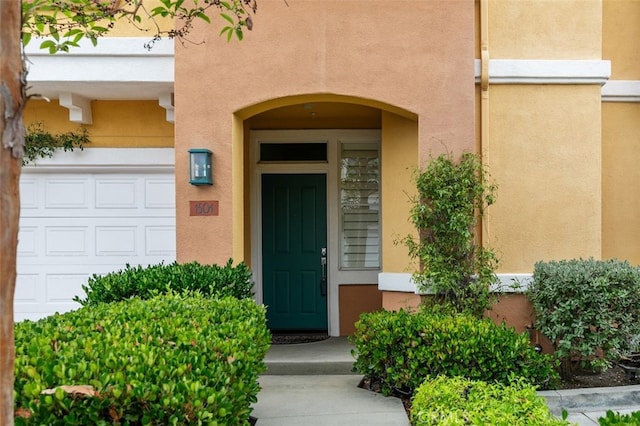 1501 Reggio Aisle, Irvine, CA 92606 - doorway to property featuring stucco siding and a garage