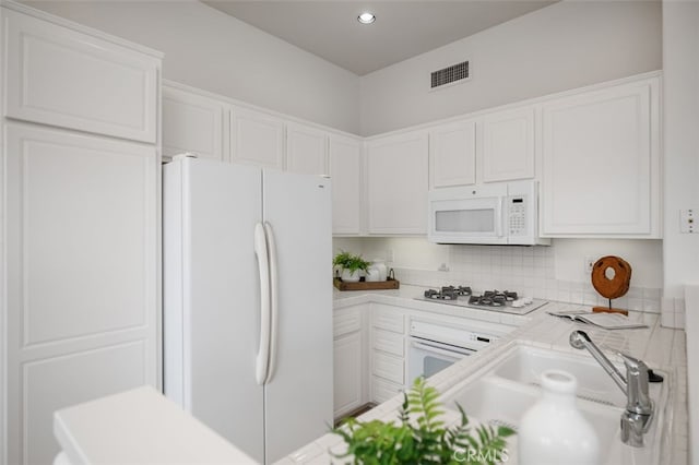 1501 Reggio Aisle, Irvine, CA 92606 - kitchen with white appliances, white cabinetry, tasteful backsplash, and recessed lighting