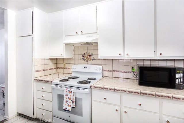 967 S Citron St Unit 3, Anaheim, CA 92805 - kitchen with under cabinet range hood, white electric range, black microwave, white cabinetry, and light countertops