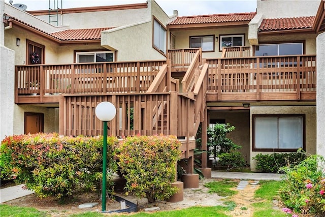 967 S Citron St Unit 3, Anaheim, CA 92805 - rear view of property featuring stucco siding, a tile roof, and a wooden deck