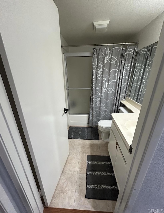 440 Citracado Pkwy Unit 30, Escondido, CA 92025 - full bath with shower / bath combo with shower curtain, vanity, tile patterned flooring, and a textured ceiling