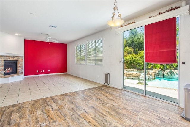 1802 Pummelo Dr, Redlands, CA 92374 - unfurnished living room with a ceiling fan, wood finished floors, and a glass covered fireplace