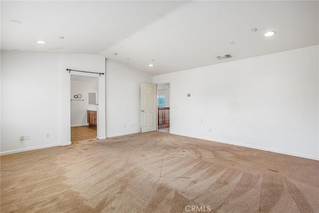 1802 Pummelo Dr, Redlands, CA 92374 - unfurnished bedroom featuring vaulted ceiling, light carpet, recessed lighting, and ensuite bath