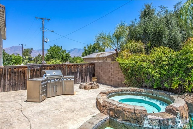 1802 Pummelo Dr, Redlands, CA 92374 - fenced backyard featuring a mountain view, an in-ground hot tub, a patio, and a grill