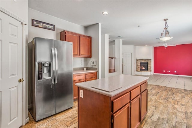 1802 Pummelo Dr, Redlands, CA 92374 - kitchen with stainless steel fridge, wood finish floors, light countertops, a kitchen island, and pendant lighting